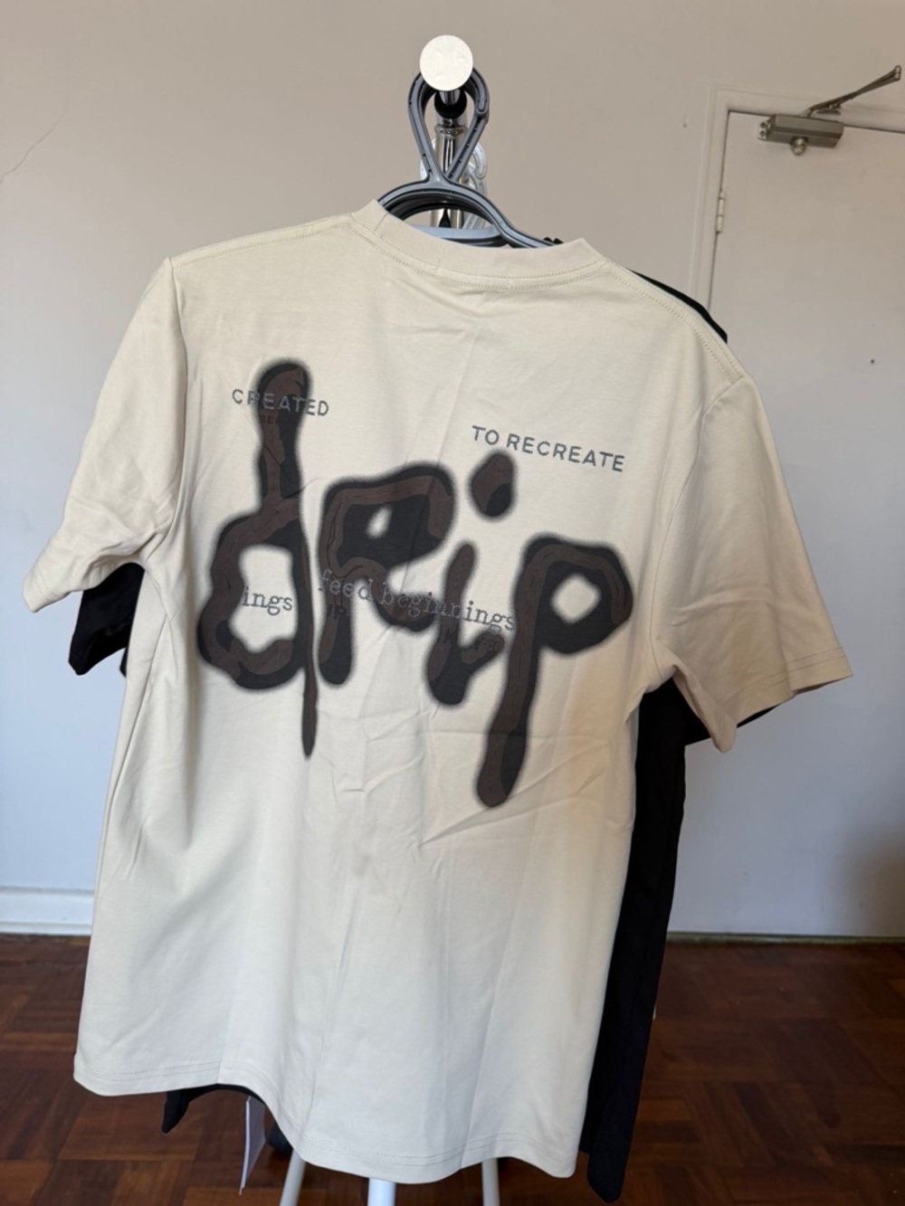The Marathon Clothing Cream Short-Sleeve Tee with Black 'drip' Back Graphic